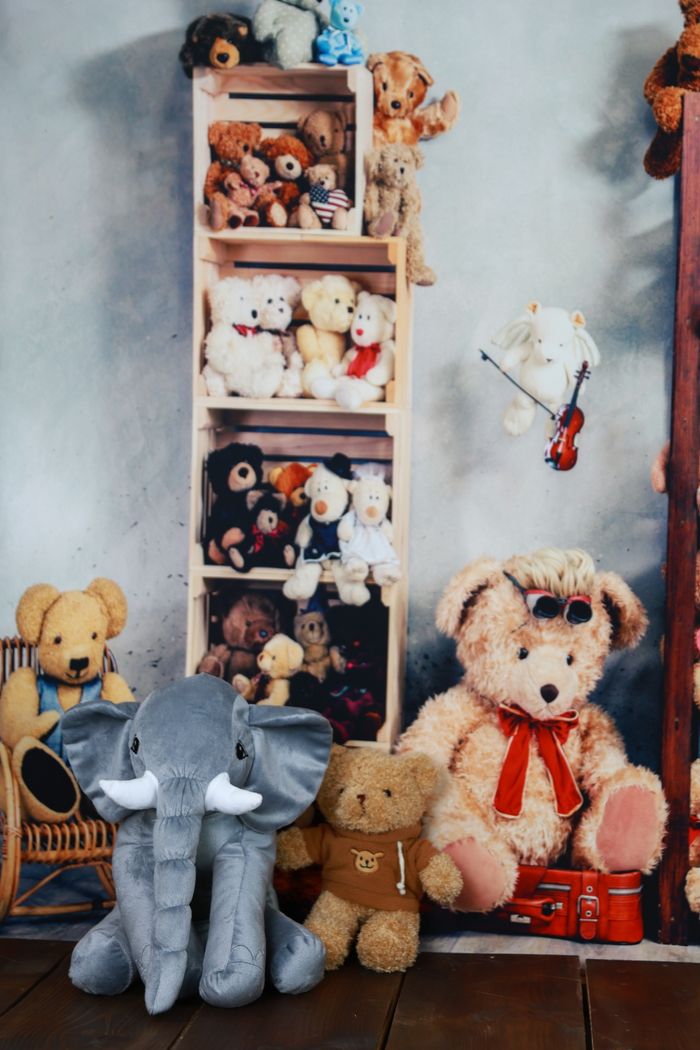 Crafting Captivating Headlines: Your awesome post title goes here Charming arrangement of plush teddy bears and a stuffed elephant in a cozy indoor setting.