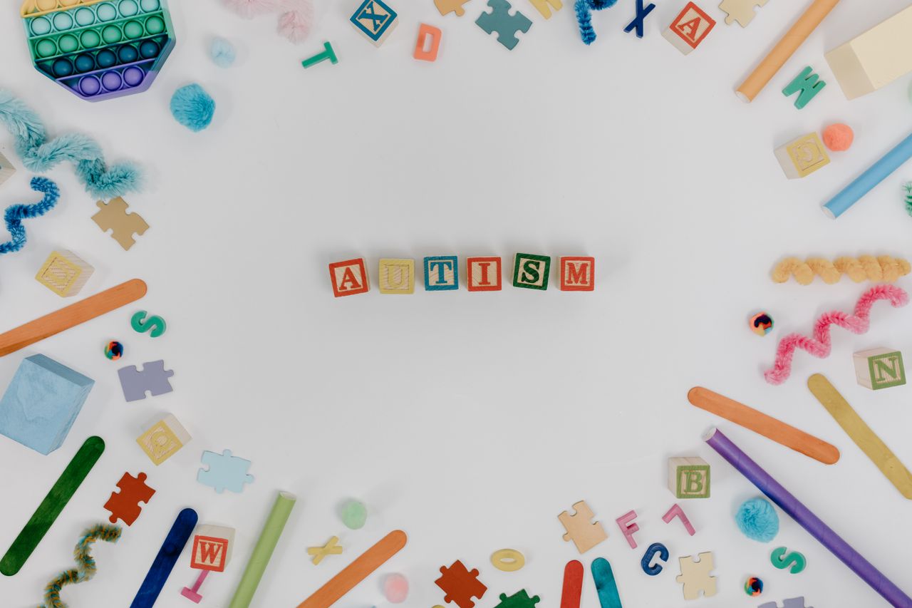 Brightly colored blocks and toys arranged around the word autism, promoting awareness.